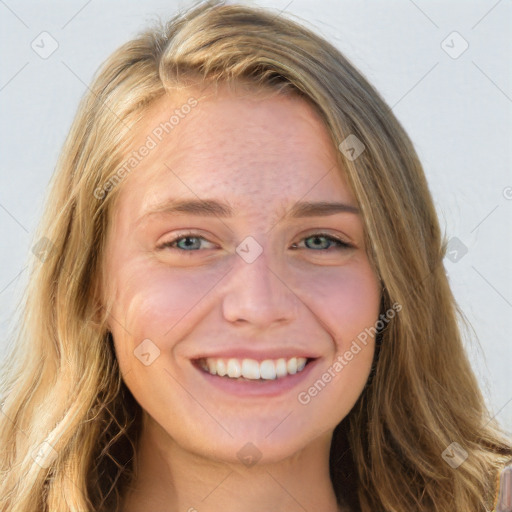 Joyful white young-adult female with long  brown hair and blue eyes