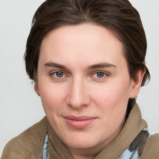 Joyful white young-adult female with medium  brown hair and grey eyes