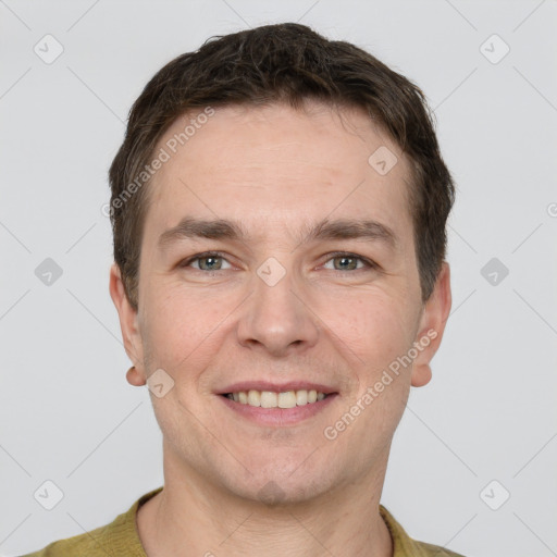 Joyful white adult male with short  brown hair and grey eyes