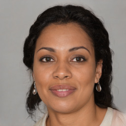 Joyful black adult female with medium  brown hair and brown eyes