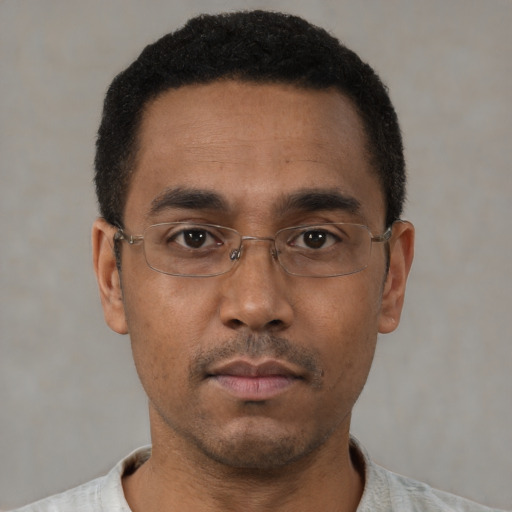 Neutral black adult male with short  black hair and brown eyes
