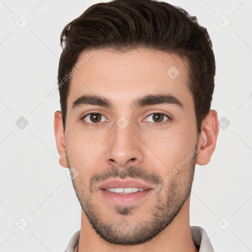 Joyful white young-adult male with short  brown hair and brown eyes