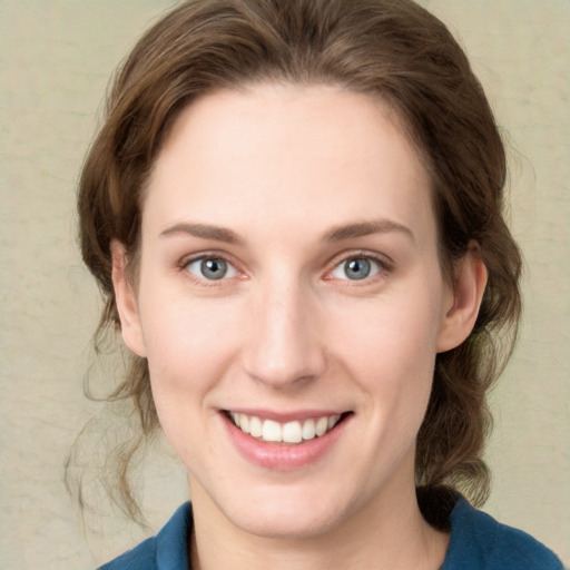 Joyful white young-adult female with medium  brown hair and green eyes