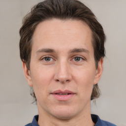 Joyful white adult male with short  brown hair and grey eyes