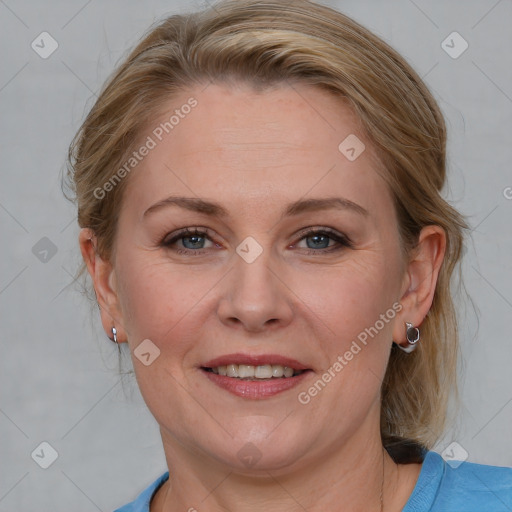 Joyful white adult female with medium  brown hair and blue eyes