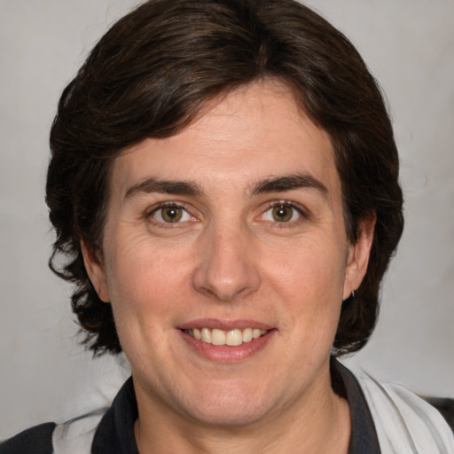 Joyful white adult female with medium  brown hair and brown eyes