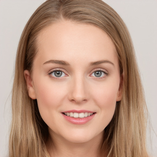 Joyful white young-adult female with long  brown hair and grey eyes