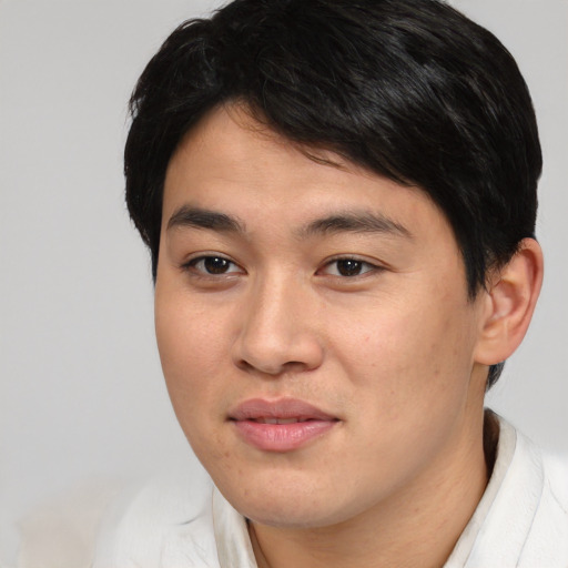 Joyful asian young-adult male with short  brown hair and brown eyes