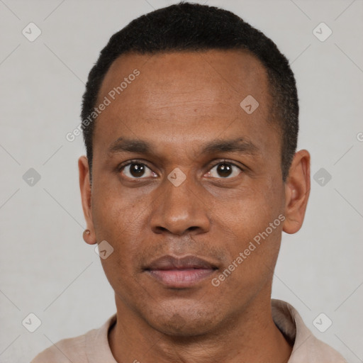 Joyful black young-adult male with short  black hair and brown eyes