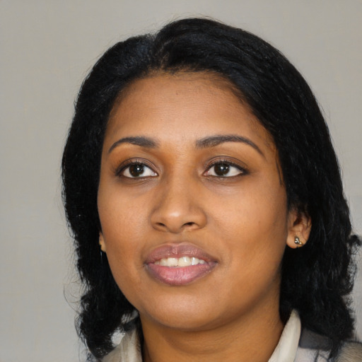 Joyful black young-adult female with medium  black hair and brown eyes