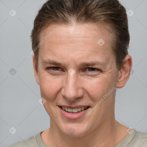 Joyful white adult male with short  brown hair and grey eyes