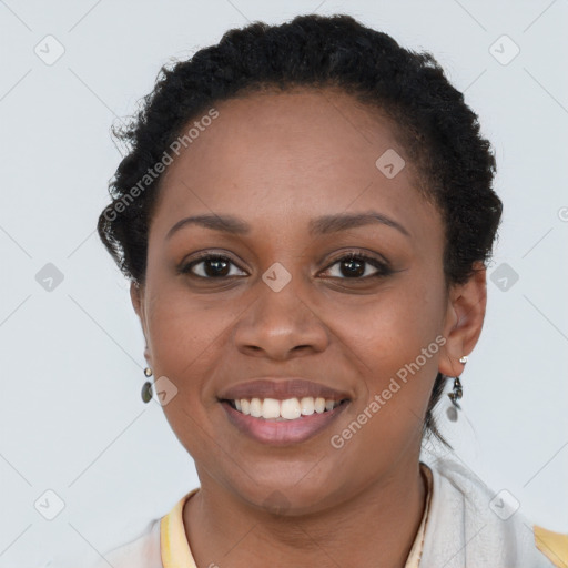 Joyful black young-adult female with short  brown hair and brown eyes