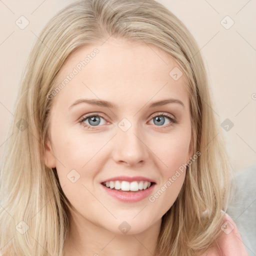 Joyful white young-adult female with long  brown hair and blue eyes