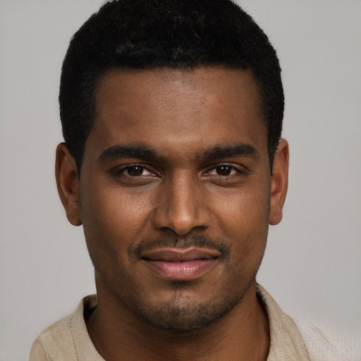 Joyful black young-adult male with short  brown hair and brown eyes