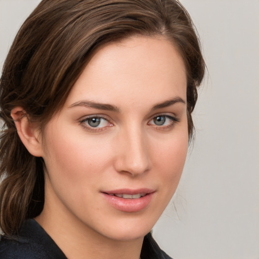 Joyful white young-adult female with medium  brown hair and grey eyes