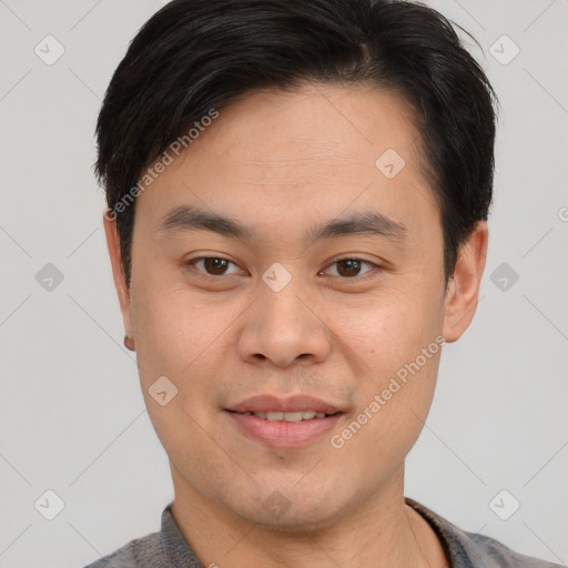 Joyful asian young-adult male with short  brown hair and brown eyes