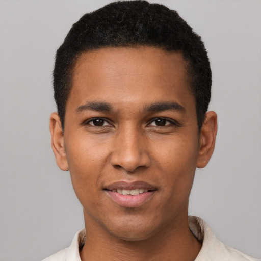 Joyful black young-adult male with short  black hair and brown eyes