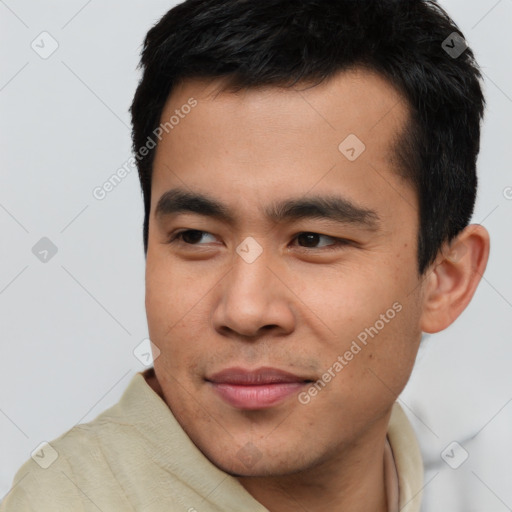 Joyful asian young-adult male with short  black hair and brown eyes