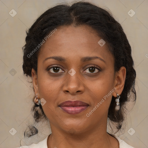 Joyful black adult female with medium  brown hair and brown eyes