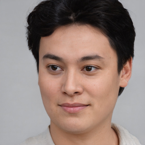 Joyful asian young-adult male with short  brown hair and brown eyes