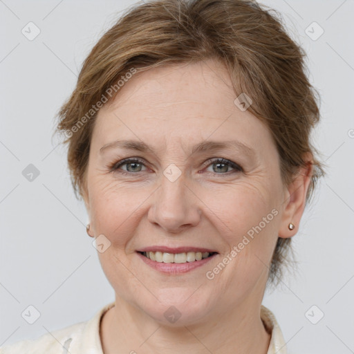 Joyful white adult female with medium  brown hair and grey eyes