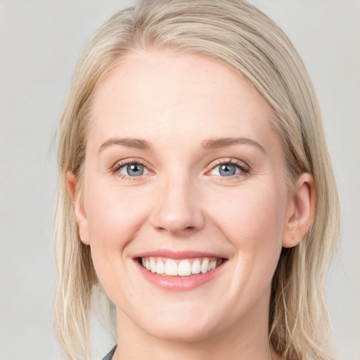 Joyful white young-adult female with medium  brown hair and blue eyes