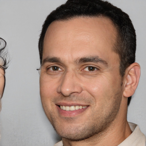 Joyful white adult male with short  brown hair and brown eyes