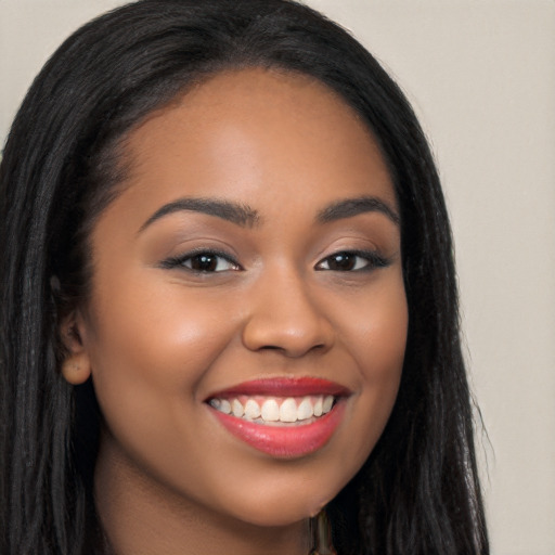 Joyful latino young-adult female with long  black hair and brown eyes