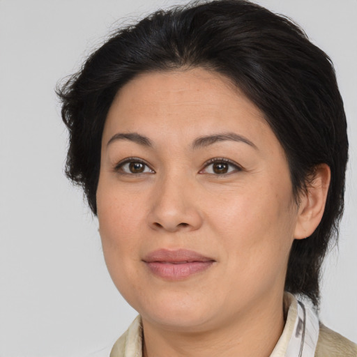Joyful asian adult female with medium  brown hair and brown eyes