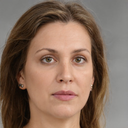 Joyful white young-adult female with long  brown hair and green eyes