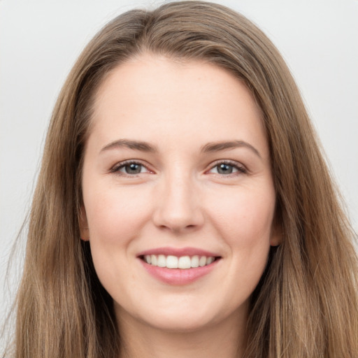 Joyful white young-adult female with long  brown hair and grey eyes