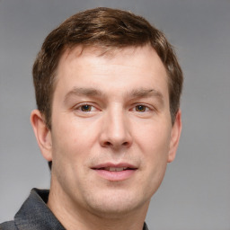 Joyful white adult male with short  brown hair and grey eyes