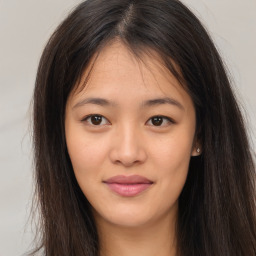 Joyful asian young-adult female with long  brown hair and brown eyes