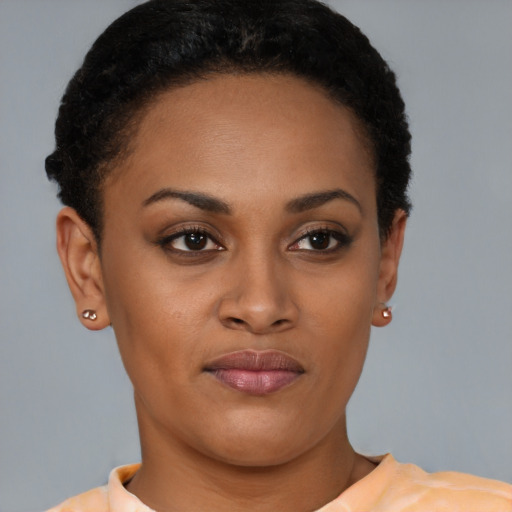 Joyful latino young-adult female with short  brown hair and brown eyes