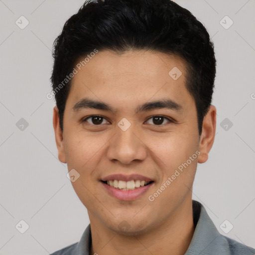 Joyful latino young-adult male with short  black hair and brown eyes