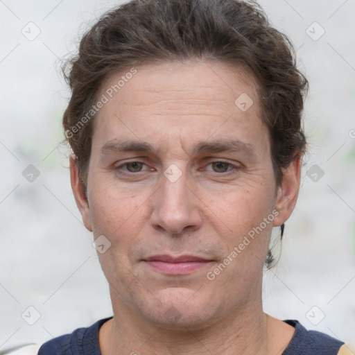 Joyful white adult male with short  brown hair and grey eyes