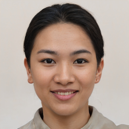 Joyful asian young-adult female with short  brown hair and brown eyes