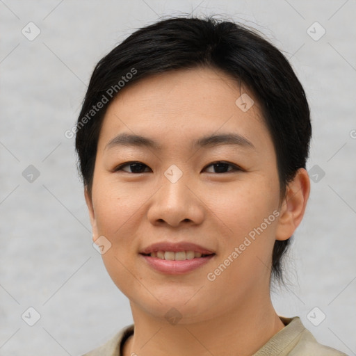 Joyful asian young-adult female with short  black hair and brown eyes