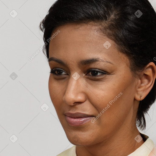 Joyful latino young-adult female with short  brown hair and brown eyes