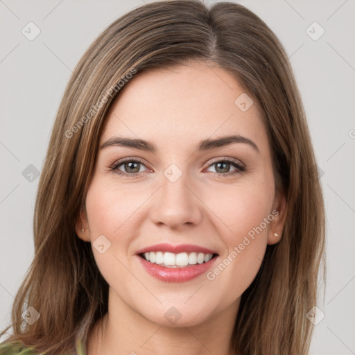 Joyful white young-adult female with long  brown hair and green eyes