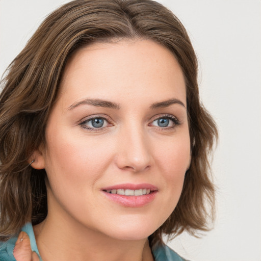 Joyful white young-adult female with medium  brown hair and blue eyes