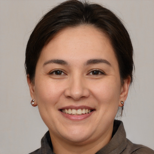 Joyful white adult female with medium  brown hair and brown eyes