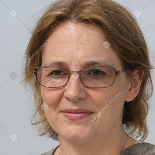 Joyful white adult female with medium  brown hair and blue eyes