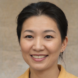 Joyful asian young-adult female with medium  brown hair and brown eyes