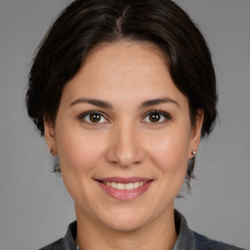 Joyful white adult female with medium  brown hair and brown eyes