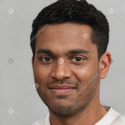 Joyful black young-adult male with short  black hair and brown eyes