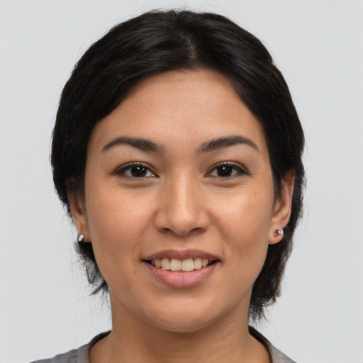 Joyful latino young-adult female with medium  black hair and brown eyes