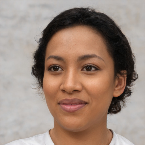 Joyful latino young-adult female with short  black hair and brown eyes