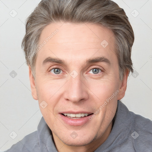 Joyful white adult male with short  brown hair and grey eyes