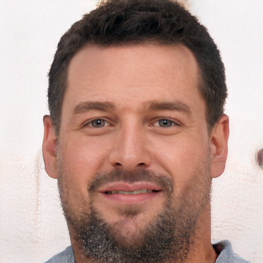 Joyful white adult male with short  brown hair and brown eyes